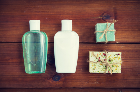 two bottles and lotion bars on a table