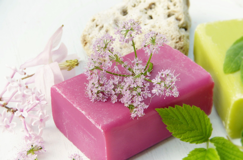 A bar of pink soap with flowers on top