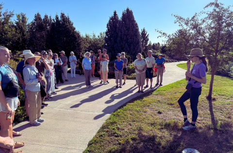 A group of people standing in a semi-circle around an instructor.png