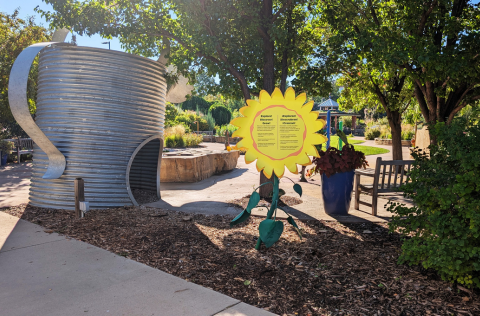 Entrance to Children's Garden with sign and large watering can