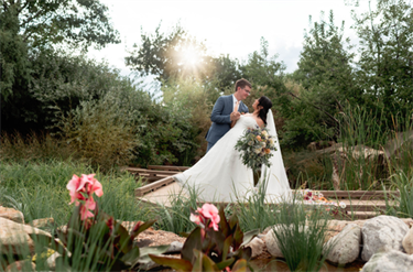 bride and groom on a wood walkway