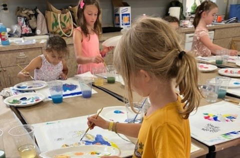 children painting at a table